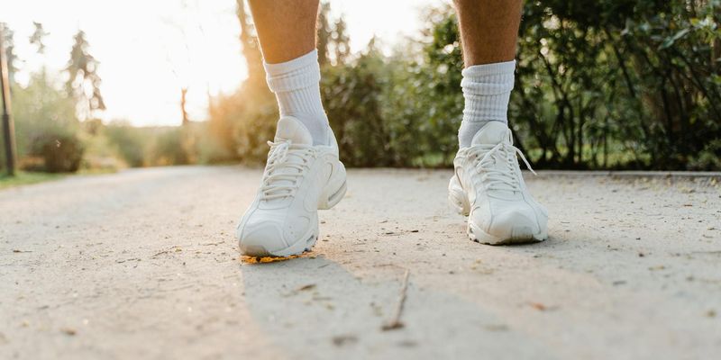 Close-up on a person's feet in athletic shoes during an exercise.